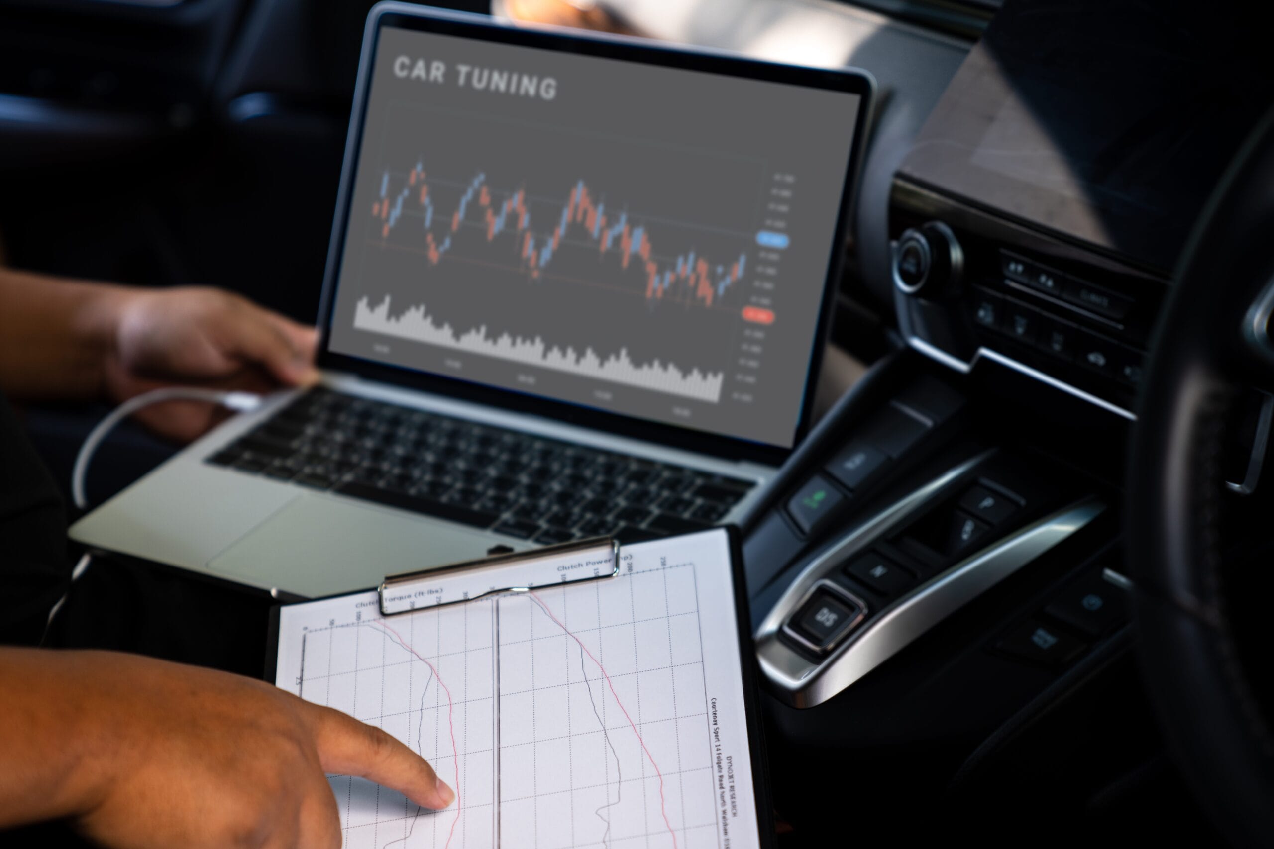 Professional car mechanics working on laptop computer for car ecu tuning.