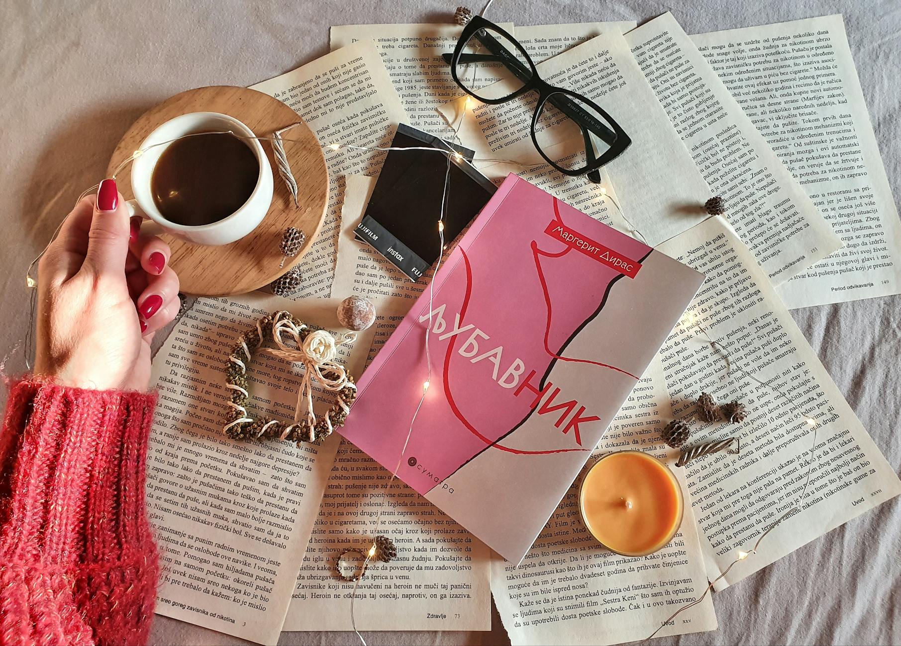 Filiżanka kawy, otwarta książka i lampki na tle wieczornego relaksu